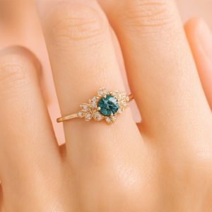 14 Karat yellow gold ring set with a .44 carat blue diamond and 18 full cut diamonds totaling .11 carat.