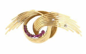 Yellow gold ruby & diamond curved spray knot brooch